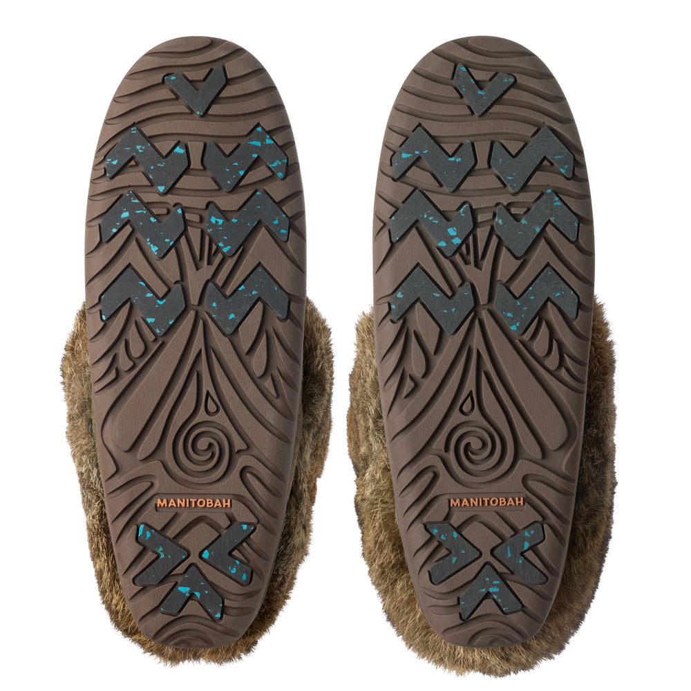 Featuring brown rubber soles with intricate patterns, zigzag grooves, and blue speckles.