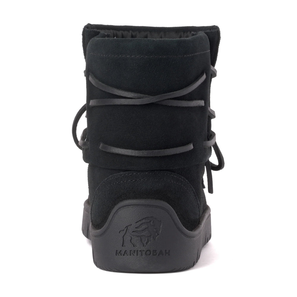 Black suede boot viewed from the back, featuring a black sole with "MANITOBAH" logo.