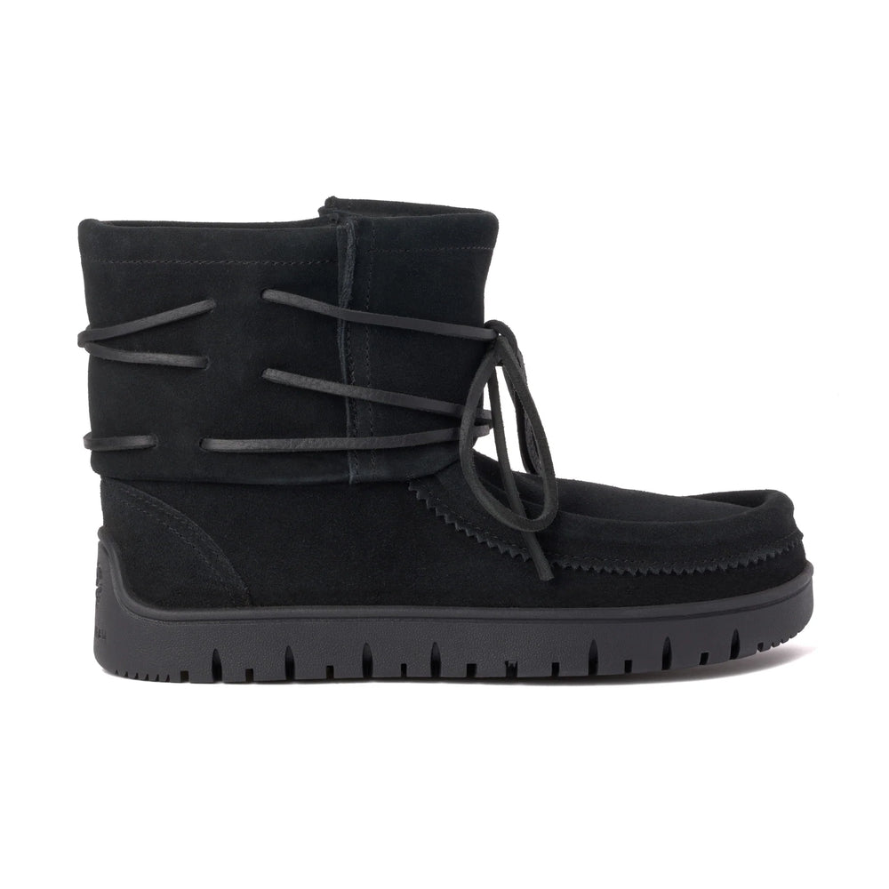 Black suede ankle boot with wraparound laces and a bow on the side. It has a moccasin-style toe and a black rubber sole.