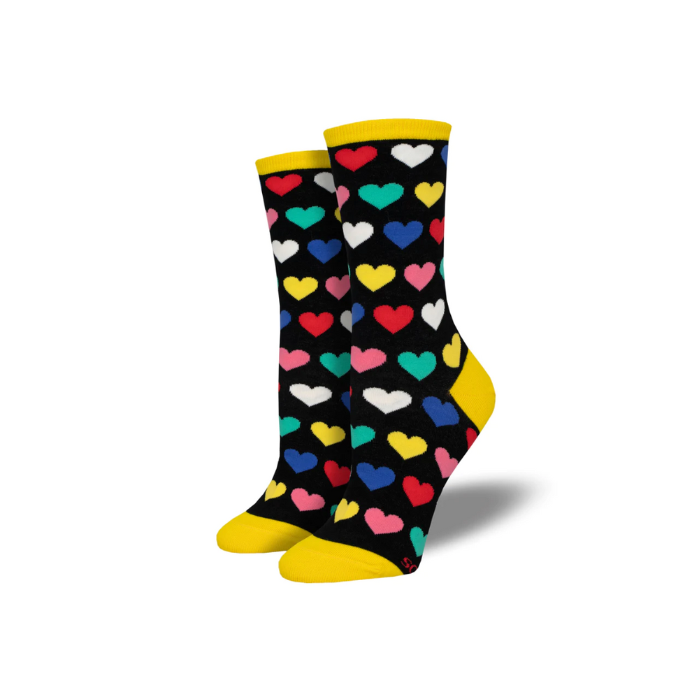 A pair of black socks with a heart pattern, including various shades of red, yellow, and blue hearts, and a yellow cuff.