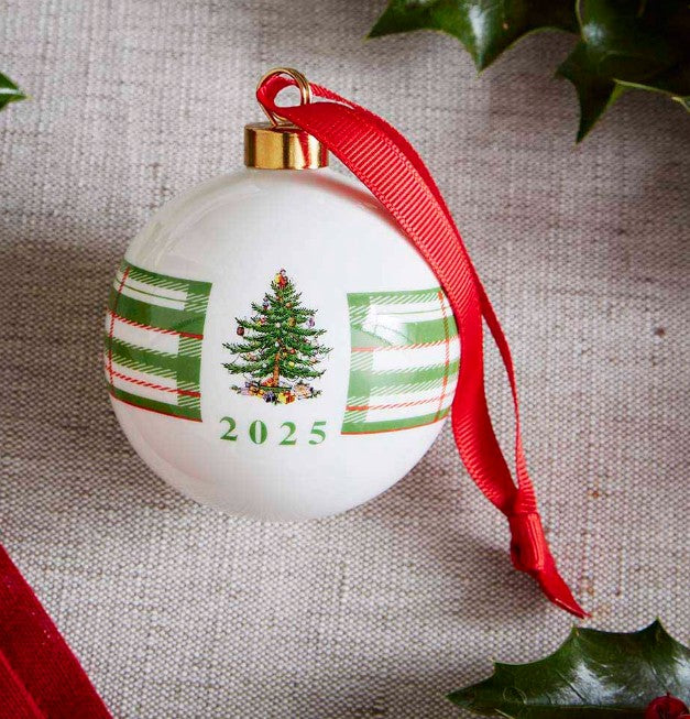 Christmas ornament with a tree design, red ribbon, and '2025' on a textured background