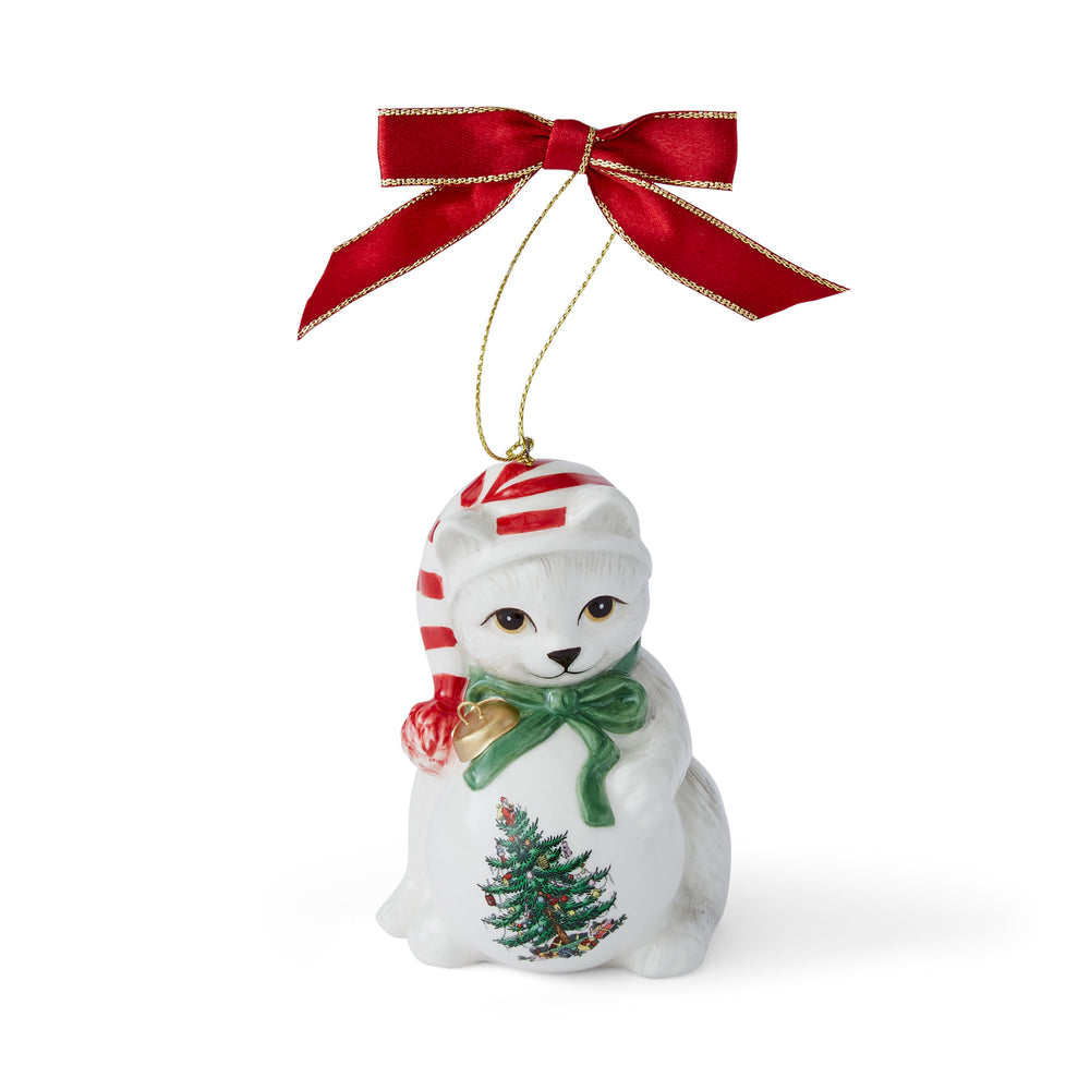 Ceramic ornament of a white kitten in a red-striped hat and green bow, adorned with a Christmas tree design. Topped with a red ribbon, festive and charming.