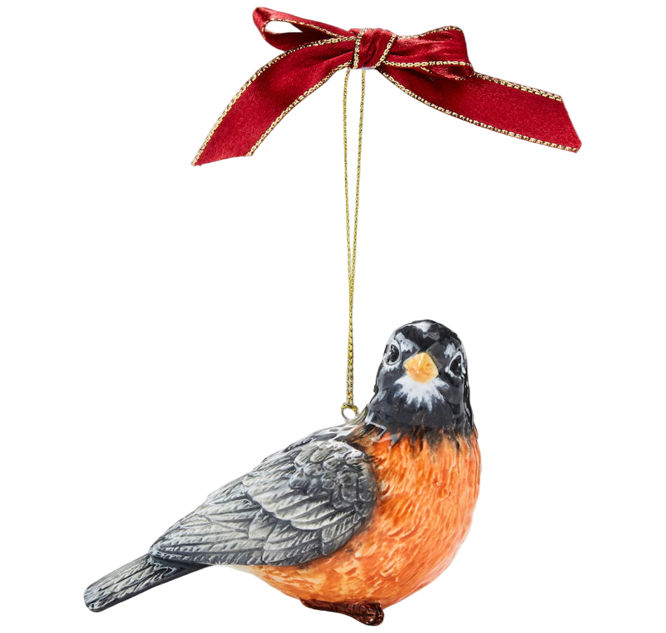 Festive robin ornament with detailed gray wings and orange breast hangs from a gold string with a red bow, conveying a cheerful, holiday vibe.