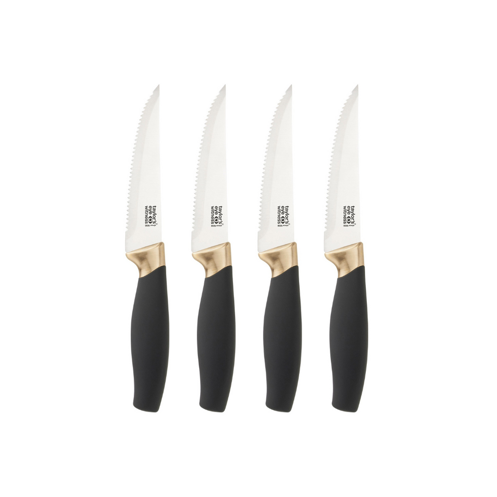 A set of four stainless steel steak knives with black handles and gold accents on the bolster and finger guard.