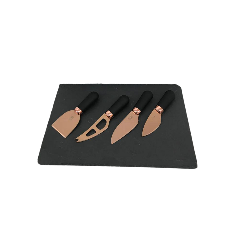 A set of four rose gold cheese knives with black handles and a matching rose gold plated band, displayed on a dark slate cheese serving board.