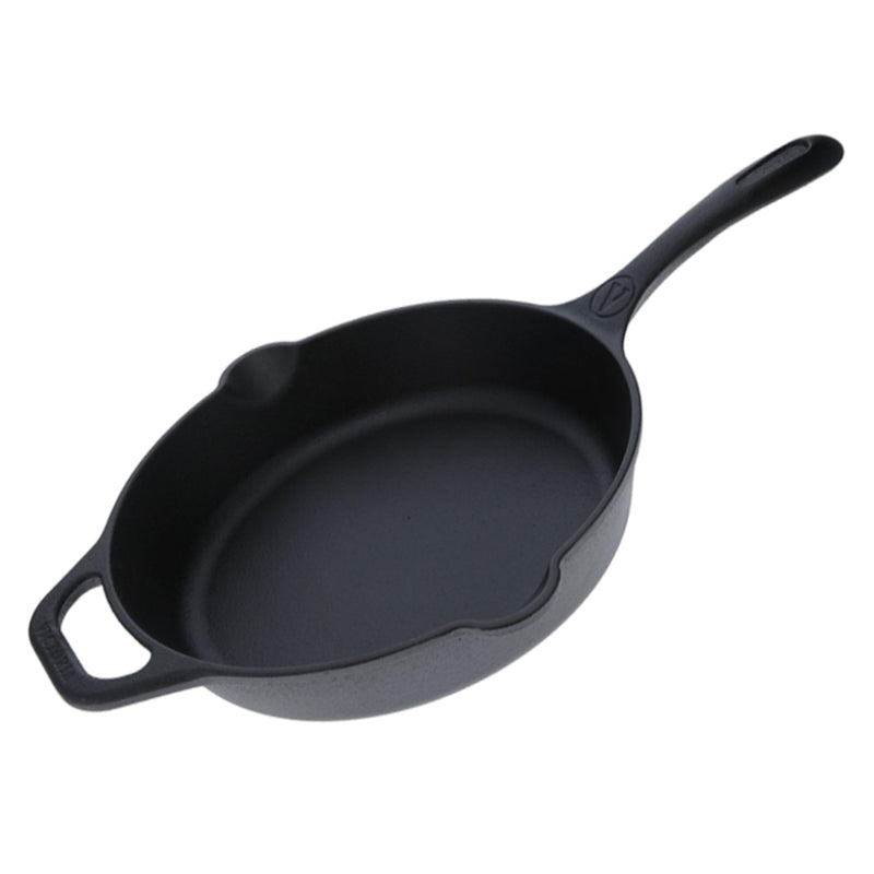 Black cast iron skillet on a white background
