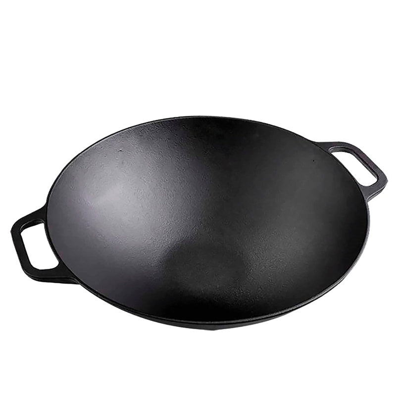 Black cast iron wok on a white background