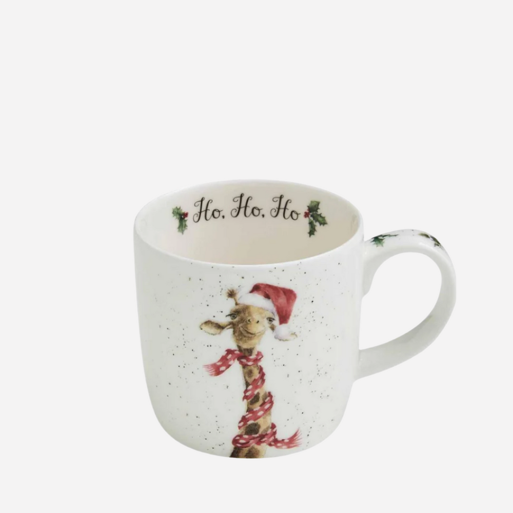 A white bone china mug with a giraffe wearing a Santa hat and scarf, and the text 'Ho Ho Ho' on the inside. The mug is lightweight and appears to be part of a Christmas-themed collection.