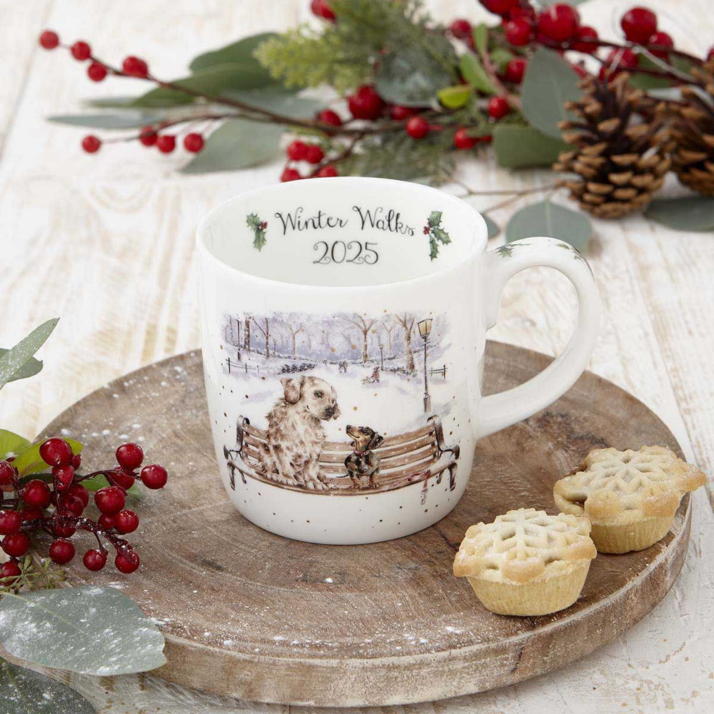 White mug with winter scene design on a wooden tray with festive decorations