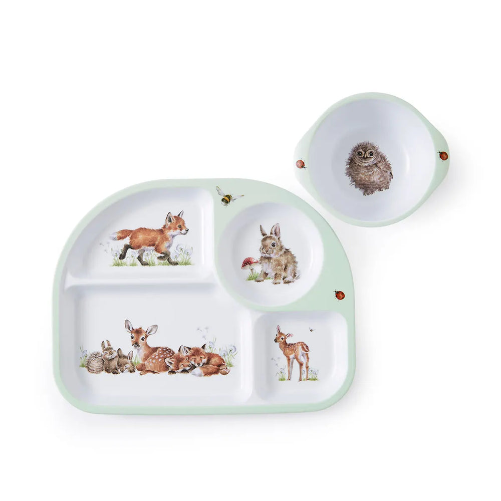 A divided plate and bowl set with illustrations of animals including a fox, an owl, a rabbit, and a deer, in green, white, and brown colors.