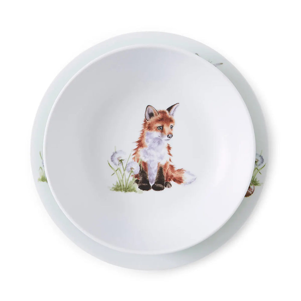 A white ceramic bowl with a illustration of a forest animal, specifically a fox, in the center.