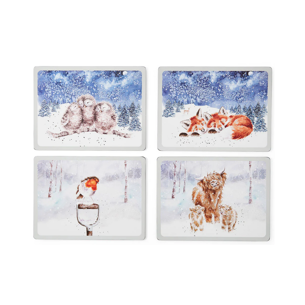A set of four rectangular placemats with cork backing, each featuring a Christmas-themed illustration of a snowy scene with a fox, robin, and other winter wildlife.