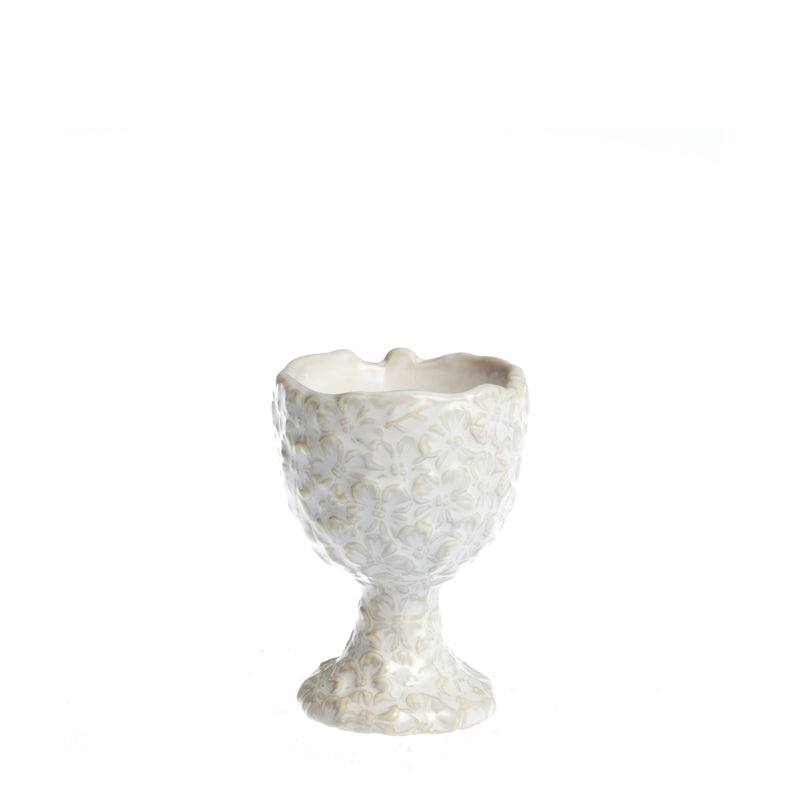 Decorative white egg-shaped container with textured surface on a white background