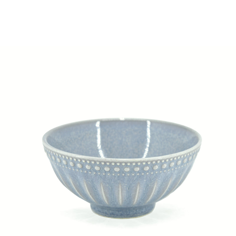 A blue reactive glazed stoneware bowl with a textured finish and distinctive markings.