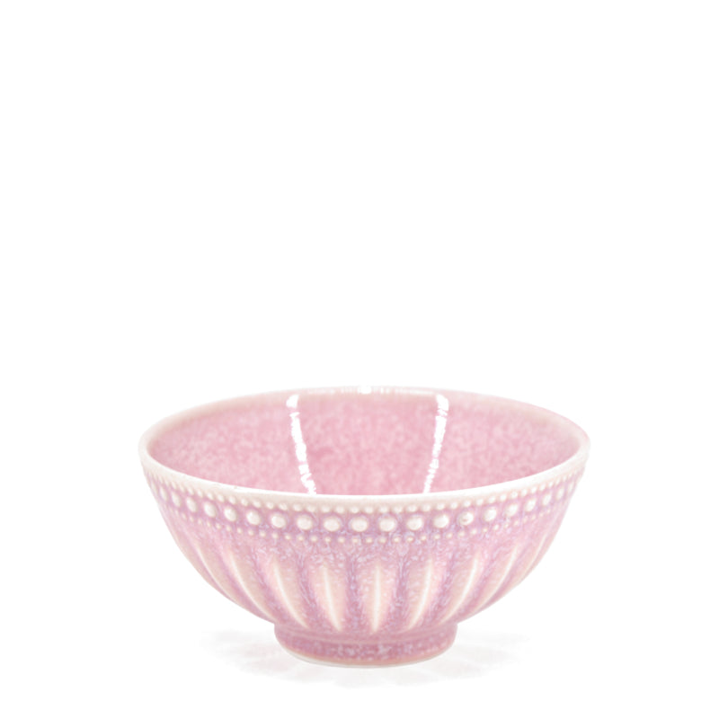 A pink reactive glazed stoneware bowl with textured patterns and a distinctive marking, displayed against a plain background.