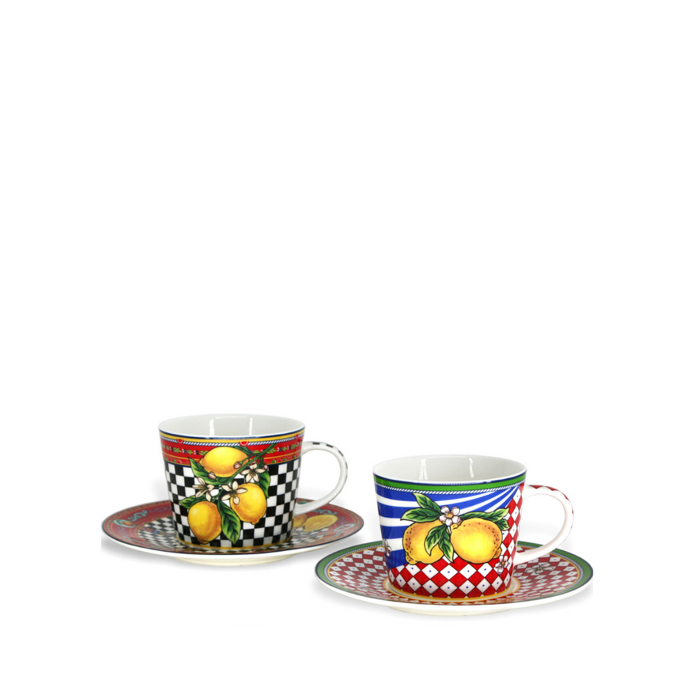 A set of two multicolored BIA Tesoro cappuccino cups with saucers, one cup with a lemon design and the other with a checkered pattern, displayed against a white background.