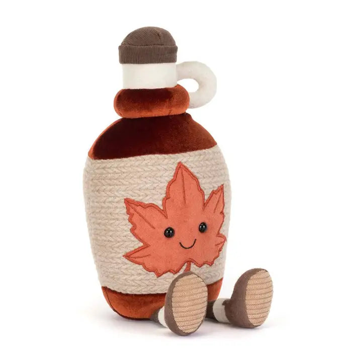 Stuffed toy bottle with a leaf design on a white background
