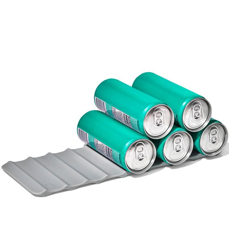 Green beer cans on a gray can carrier against a white background