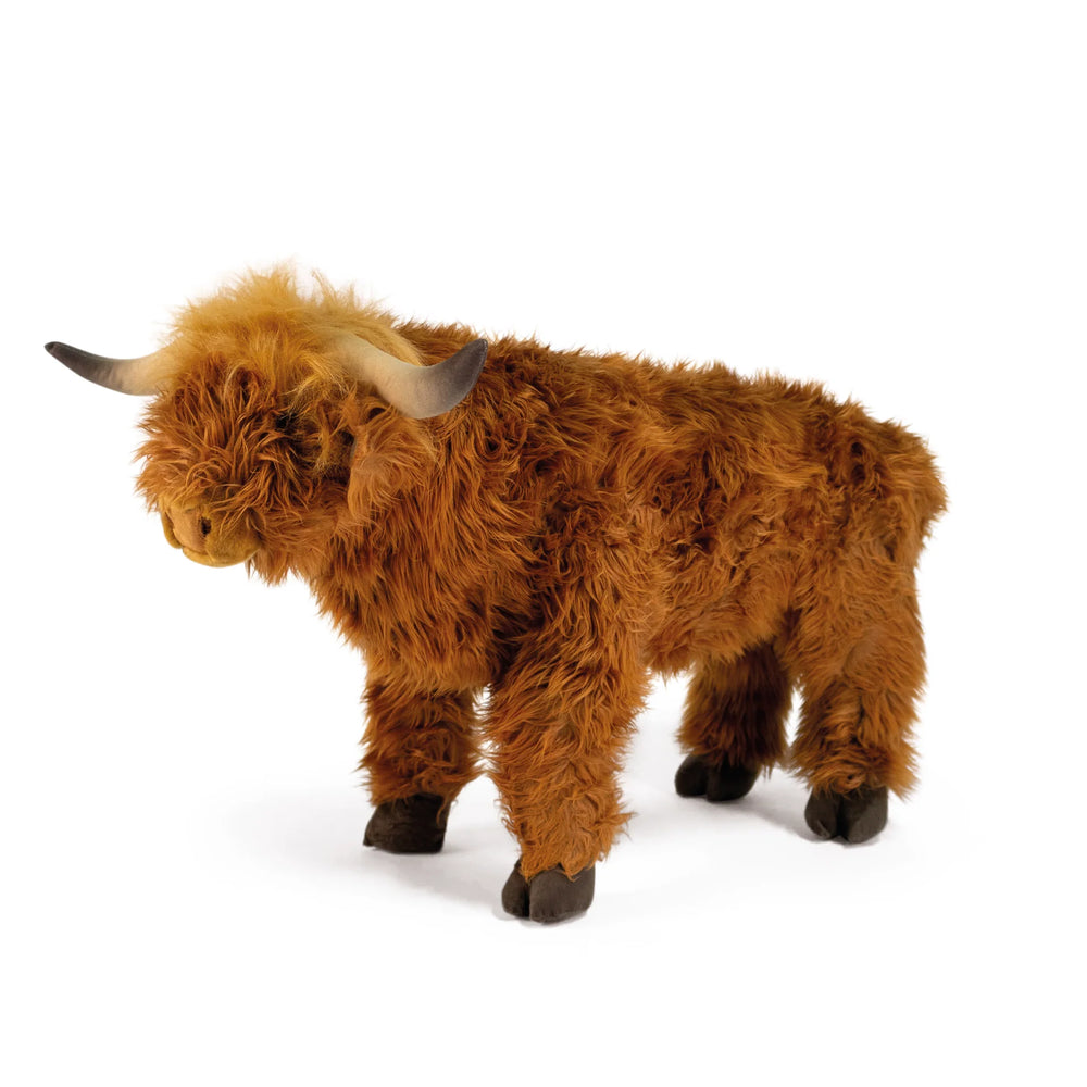 Plush toy of a brown Highland cow on a white background