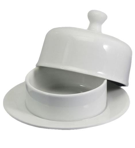 A white porcelain butter dish with a round cover, displayed on a plate.