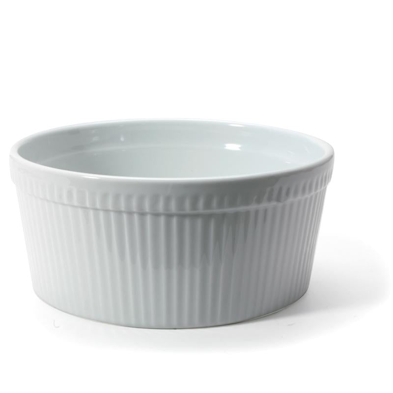 A white, round, porcelain soufflé dish with vertical ridges on the exterior.