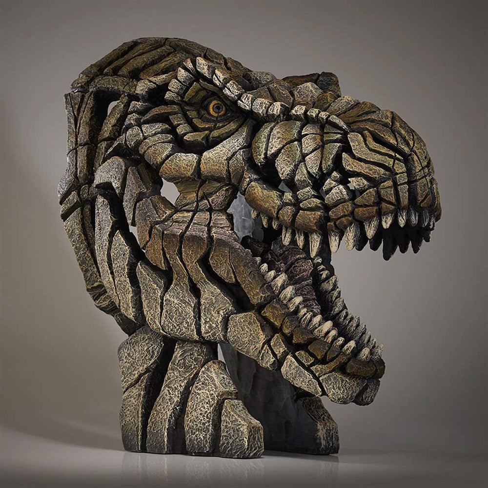 A sculpture of a Tyrannosaurus Rex bust, featuring a textured, rugged exterior resembling the appearance of dinosaur skin.