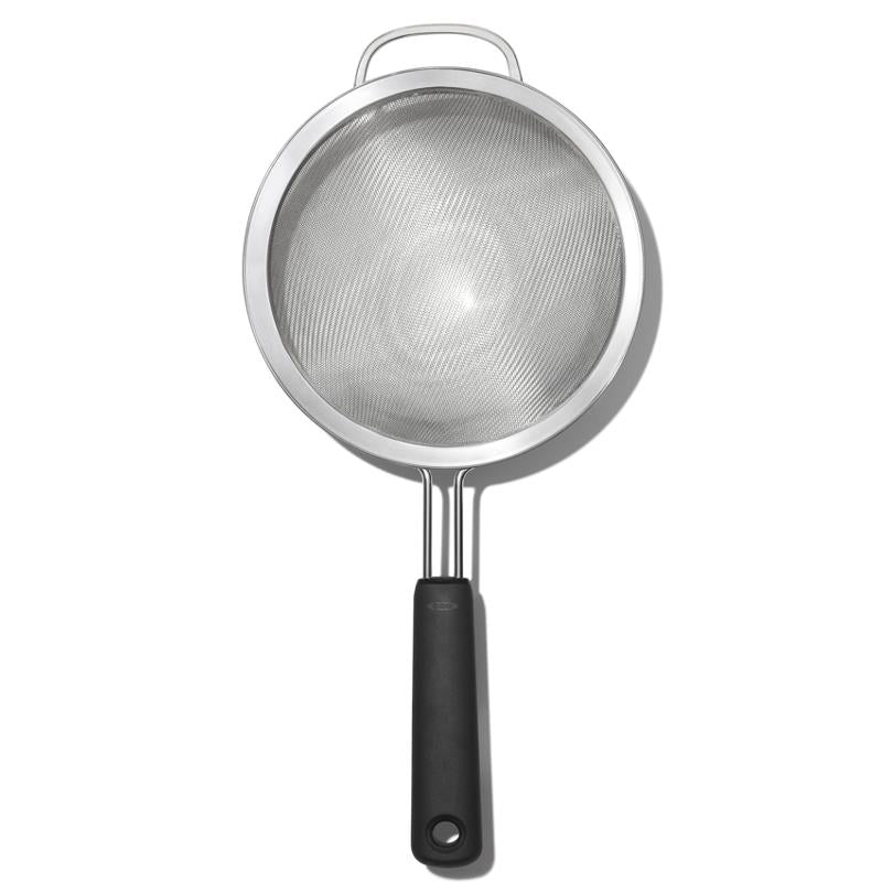 Metal strainer with a black handle on a white background