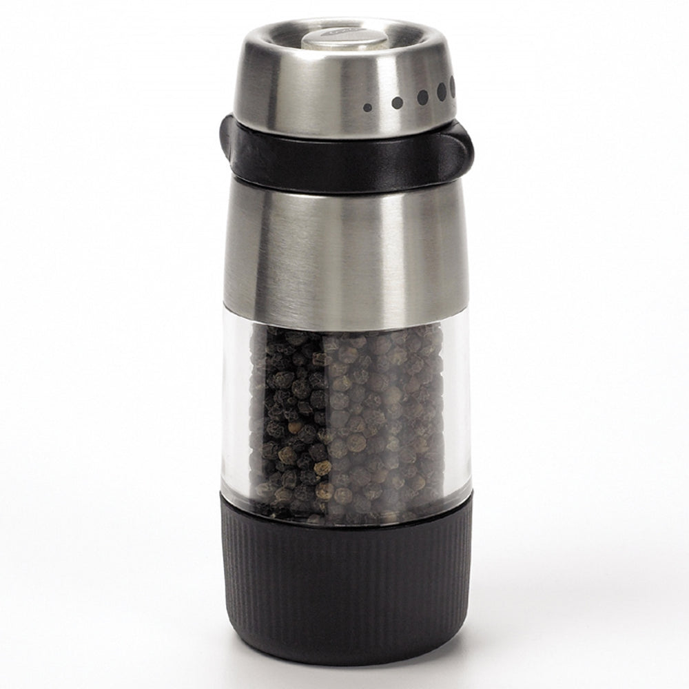 Pepper grinder with black pepper inside on a white background