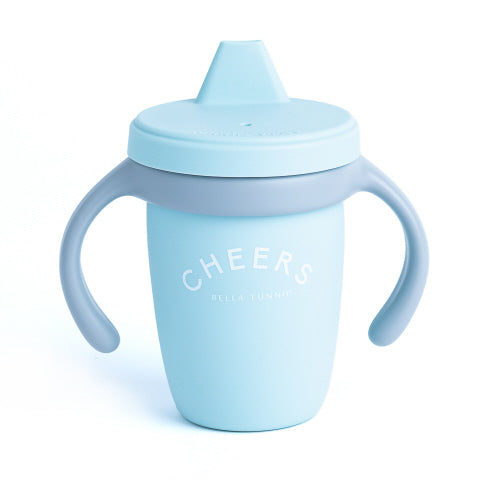 A baby blue sippy cup with gray handles and a gray lid, featuring the text 'CHEERS' on the front.
