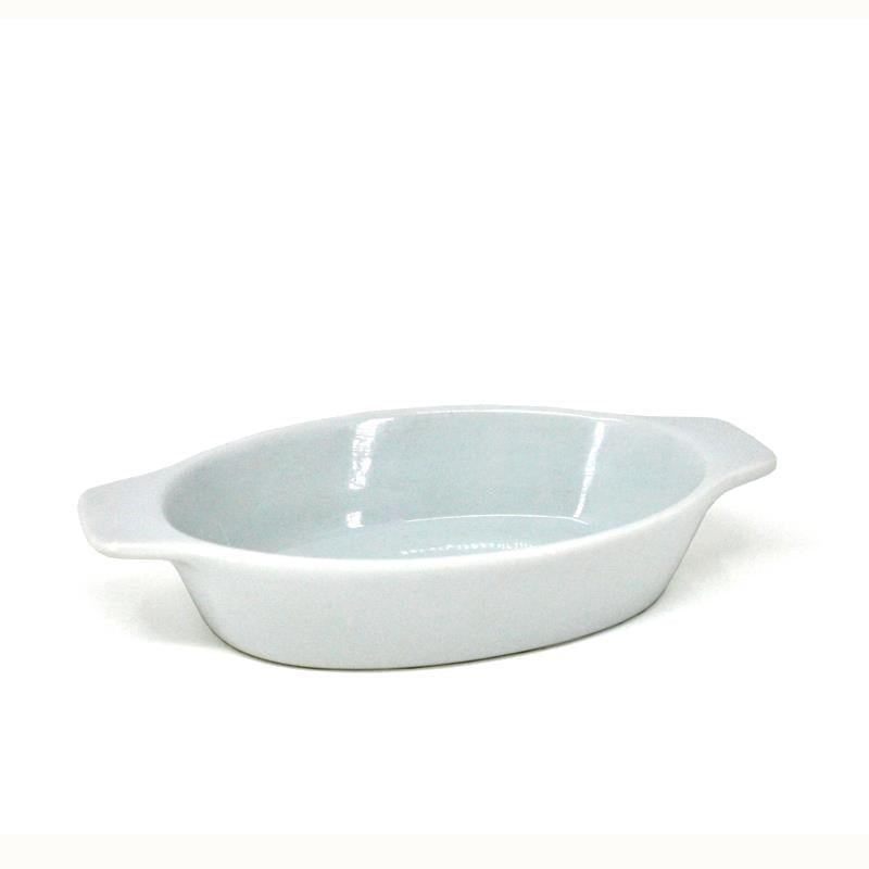 A white oval au gratin dish made of porcelain, with handles on the sides.